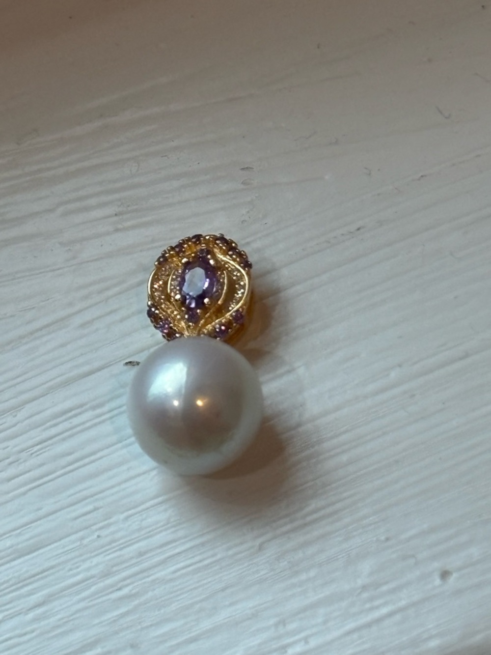 White freshwater pearl on purple and gold colored sterling silver pendant